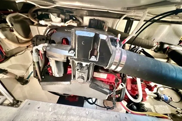 Slide: The Image of Engine compartment of a 2004 Carver 420 Mariner, showcasing mechanical components and wiring. - 38