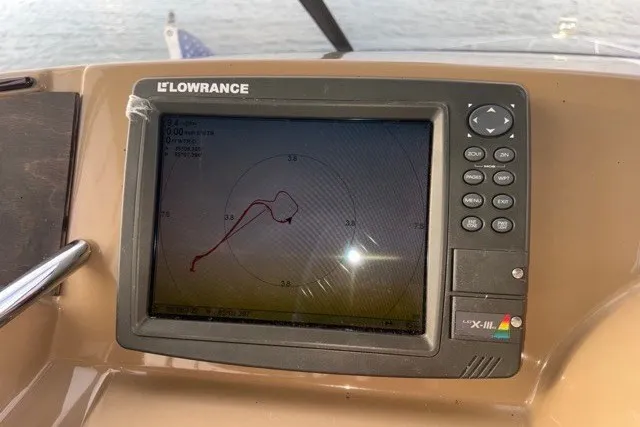 Slide: The Image of Lowrance navigation system on 2004 Carver 420 Mariner boat dashboard, displaying route map. - 18