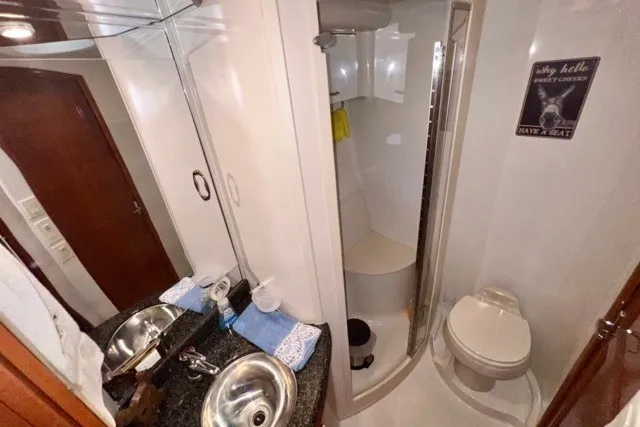 Slide: The Image of Bathroom interior of 2004 Carver 420 Mariner yacht with sink, shower, and toilet. - 24