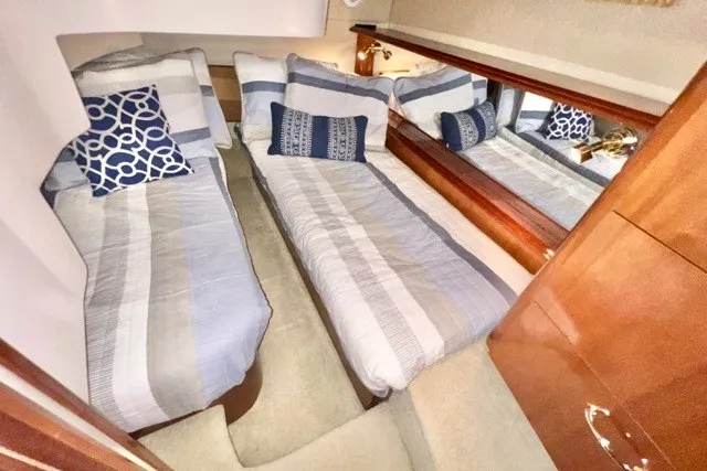 Slide: The Image of Interior of 2004 Carver 420 Mariner with twin beds and nautical-themed decor. - 26