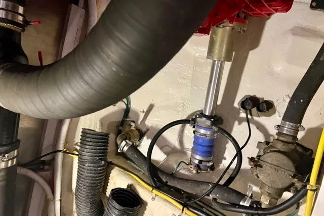Slide: The Image of Engine room of a 2004 Carver 420 Mariner with visible hoses and mechanical components. - 30