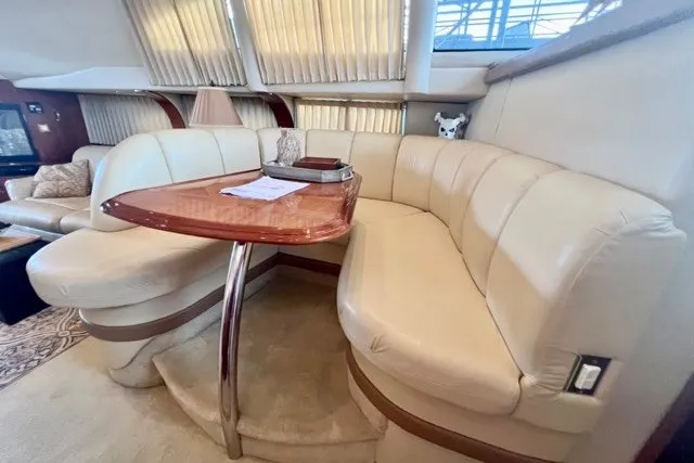 Slide: The Image of Luxurious interior of 2004 Carver 420 Mariner yacht with plush seating and elegant table. - 21