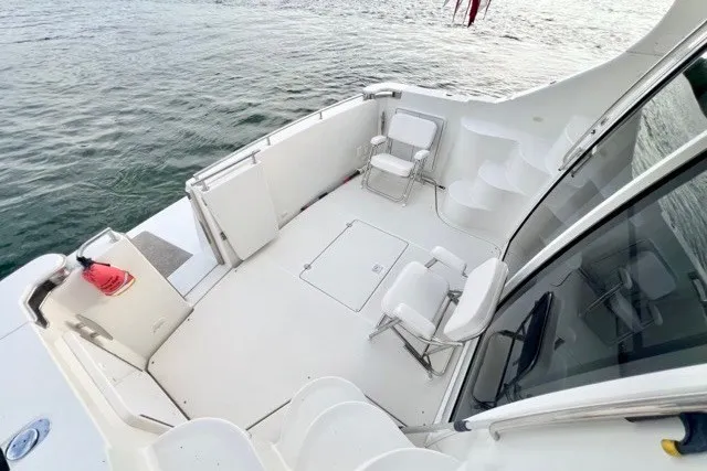 Slide: The Image of 2004 Carver 420 Mariner yacht deck with seating, overlooking calm water. - 6