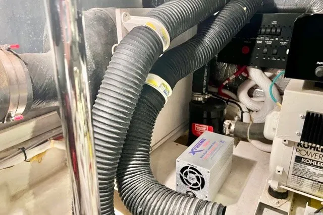 Slide: The Image of Engine room of 2004 Carver 420 Mariner with hoses and electrical components. - 32