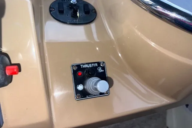 Slide: The Image of Control panel of a 2004 Carver 420 Mariner boat featuring a thruster joystick. - 16