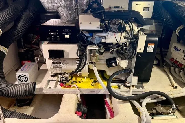 Slide: The Image of Engine room of a 2004 Carver 420 Mariner with visible mechanical components. - 27