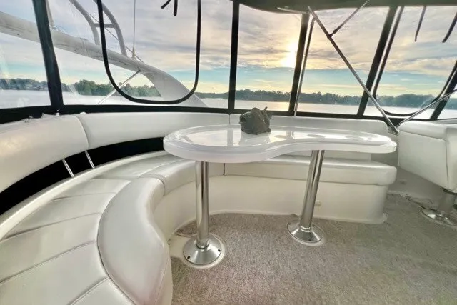 Slide: The Image of Luxurious interior of 2004 Carver 420 Mariner yacht with elegant seating and table. - 9