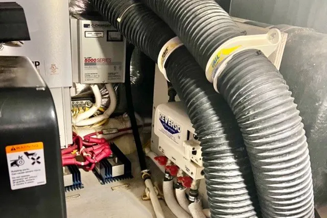 Slide: The Image of Engine room of 2004 Carver 420 Mariner with hoses and electrical components. - 31