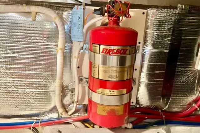 Slide: The Image of Fire extinguisher in 2004 Carver 420 Mariner engine room, surrounded by insulated wiring. - 35