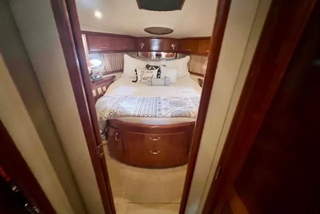 Slide: The Image of Luxurious cabin interior of 2004 Carver 420 Mariner yacht with cozy bed and elegant wood finish. - 22