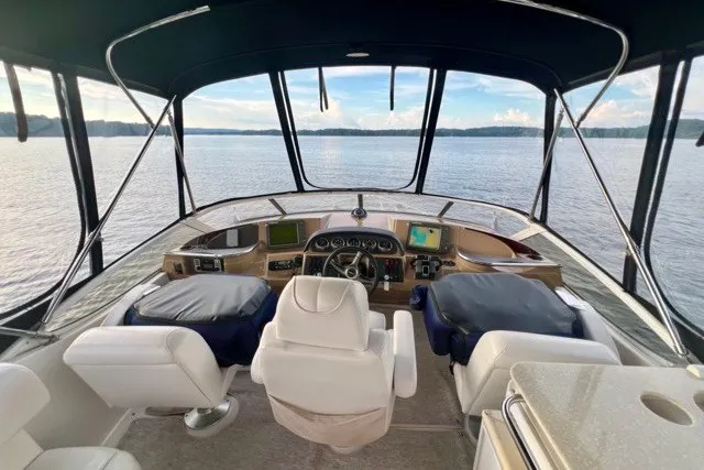 Slide: The Image of Interior view of 2004 Carver 420 Mariner yacht helm with panoramic water view. - 12