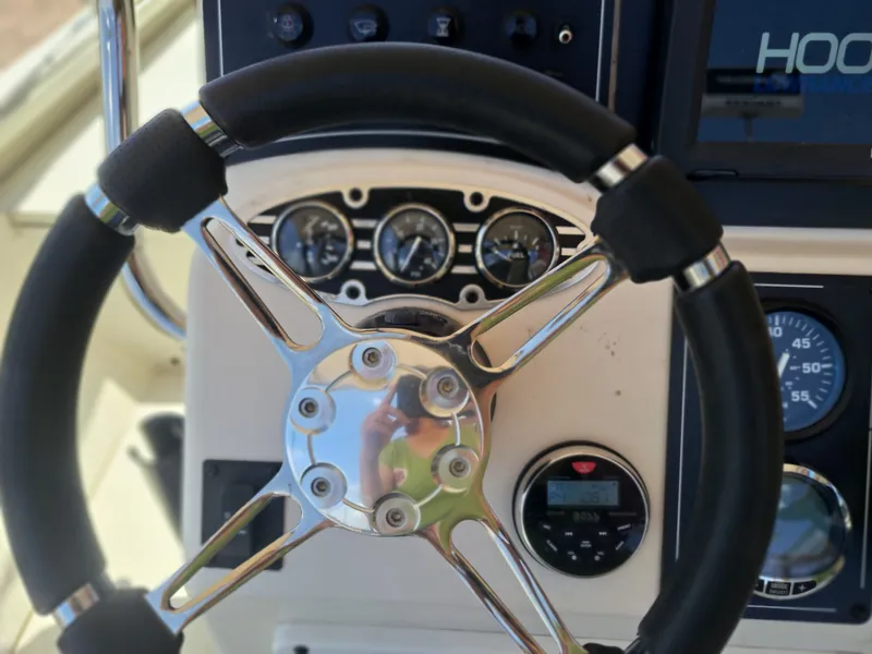 Slide: The Image of The image shows the helm of a 2022 Ranger RB190 boat with instruments and a screen. - 23