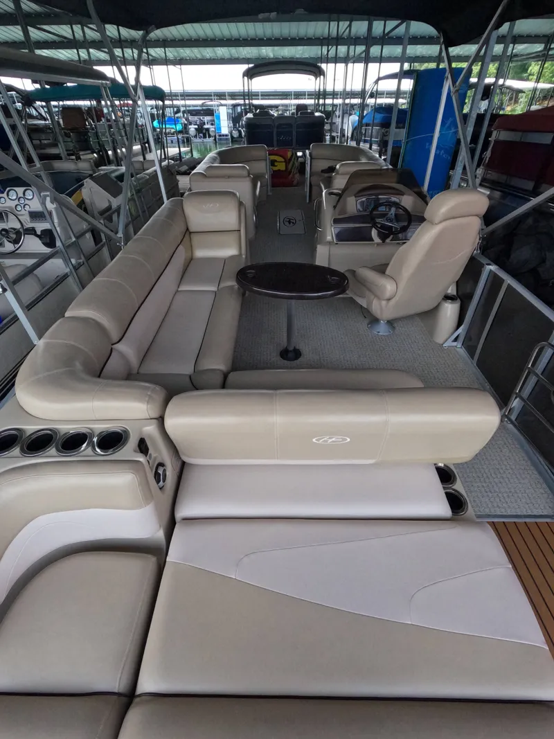 Slide: The Image of The image shows the interior of a 2013 Harris Grand Mariner 250 SEL with beige leather seating. - 9