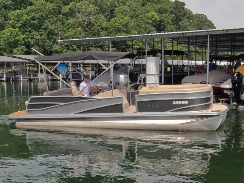 Slide: The Image of A 2013 Harris Grand Mariner 250 SEL pontoon boat on a calm lake, surrounded by trees. - 5