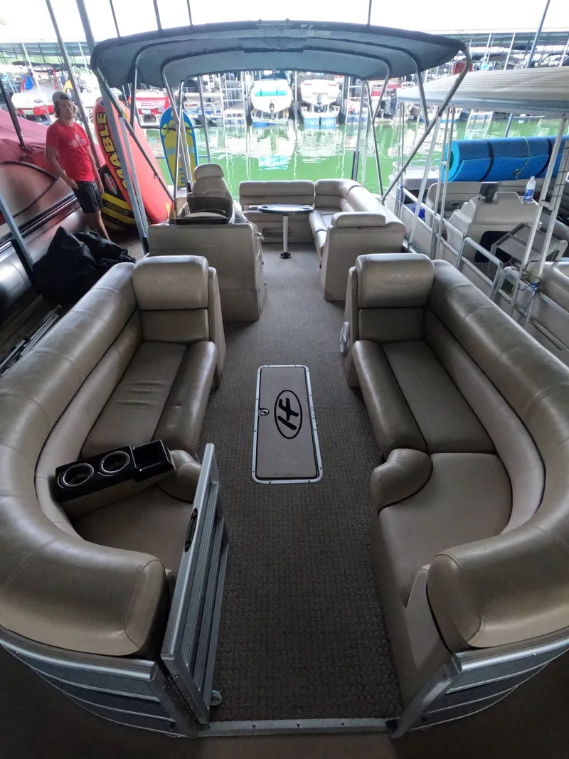Slide: The Image of The image shows the interior of a 2013 Harris Grand Mariner 250 SEL with beige leather seating. - 10