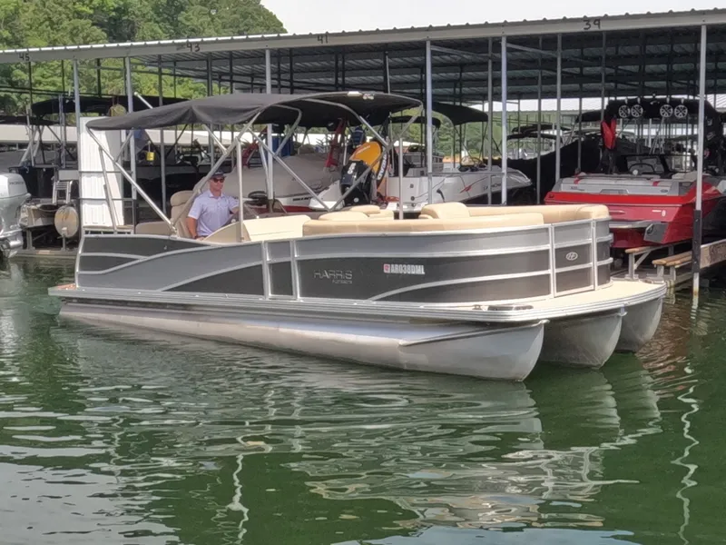 Slide: The Image of A 2013 Harris Grand Mariner 250 SEL pontoon boat is docked in the water. - 6