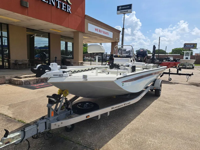 Slide: The Image of A 2022 Ranger RB190 boat on a trailer outside a building with a "We Buy Boats" sign. - 3