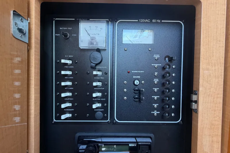 Slide: The Image of Electrical control panel of a 2016 Glastron GS 259 boat, featuring various switches and meters. - 46