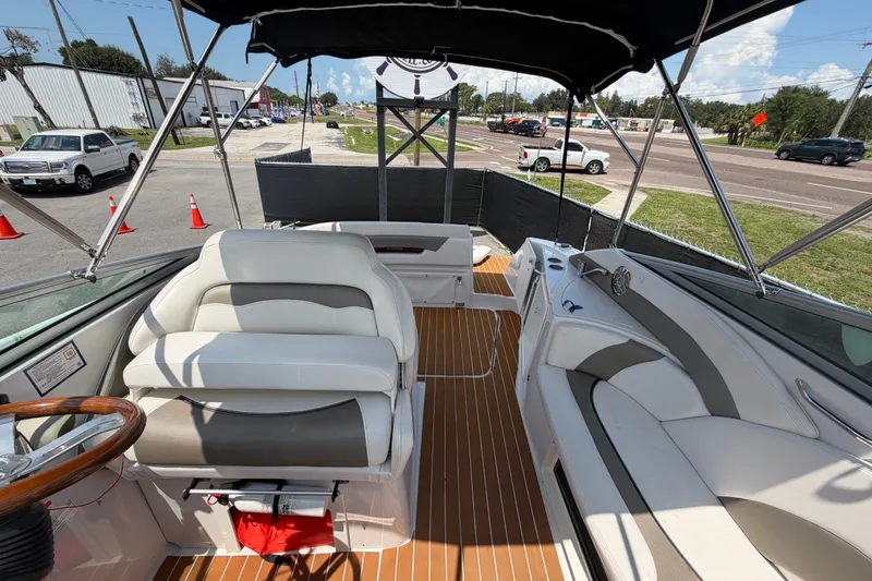Slide: The Image of 2016 Glastron GS 259 boat interior with white seating and wood accents. - 77