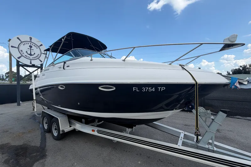 The Image of 2016 Glastron GS 259 boat on trailer, displayed outdoors with clear sky background. - 0