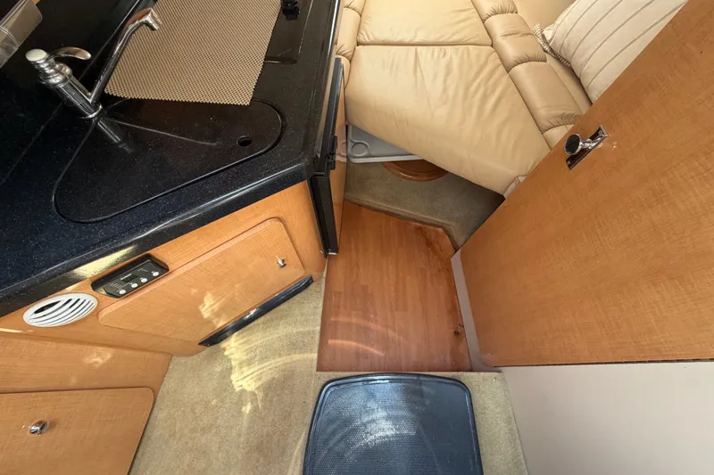 Slide: The Image of Interior of 2016 Glastron GS 259 boat with kitchenette and seating area. - 42
