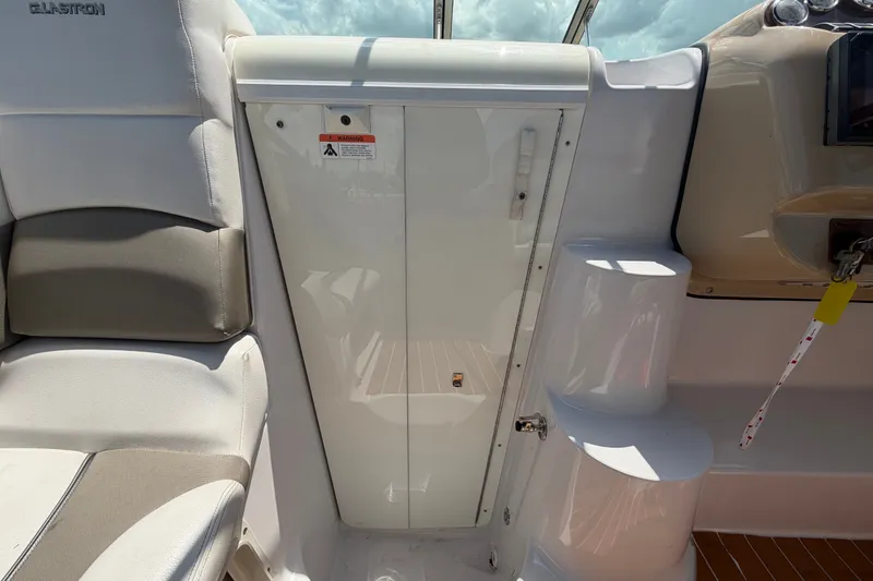 Slide: The Image of Interior of a 2016 Glastron GS 259 boat, featuring seating and storage compartments. - 38
