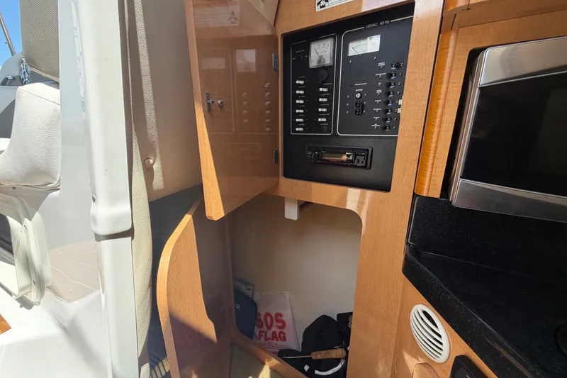 Slide: The Image of 2016 Glastron GS 259 cabin interior with control panel and storage area. - 45