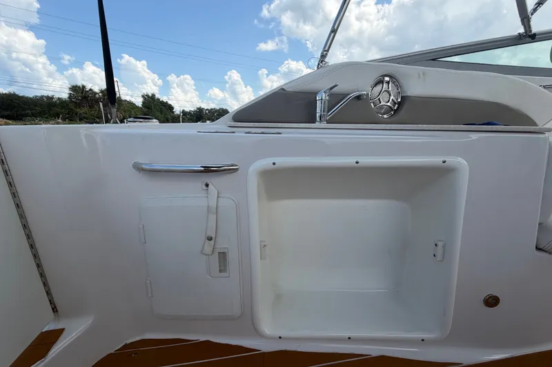 Slide: The Image of 2016 Glastron GS 259 boat interior with sink and storage compartment. - 17