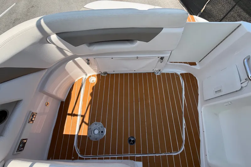 Slide: The Image of 2016 Glastron GS 259 boat interior with teak-style flooring and white seating. - 82