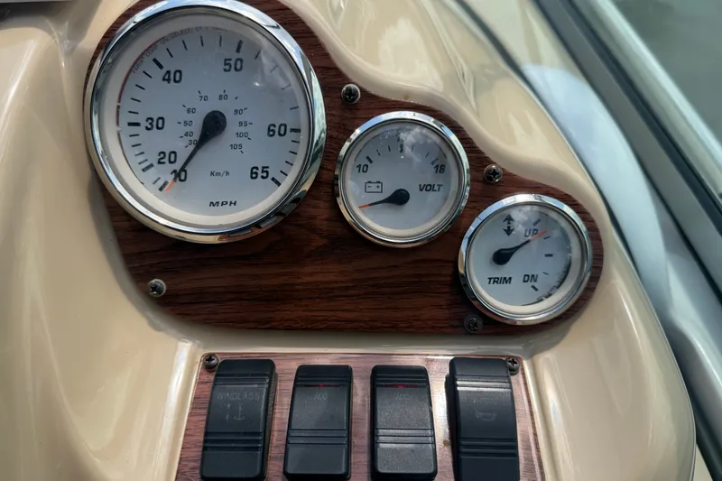 Slide: The Image of Dashboard of 2016 Glastron GS 259 boat with speedometer, voltmeter, and trim gauge. - 34