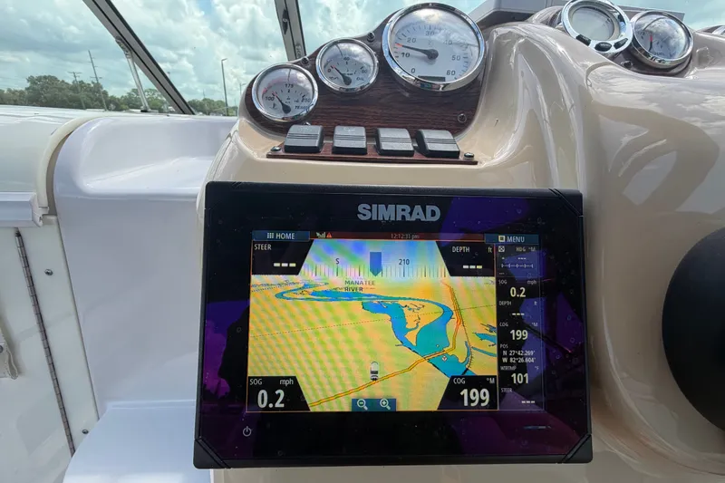 Slide: The Image of Dashboard of a 2016 Glastron GS 259 boat with Simrad navigation display. - 31