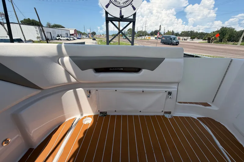 Slide: The Image of 2016 Glastron GS 259 boat interior with sleek seating and wood-patterned flooring. - 85