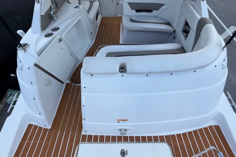 Slide: The Image of The image shows the cockpit of a 2016 Glastron GS 259 with white seating and wood flooring. - 14