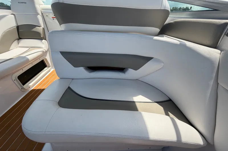 Slide: The Image of 2016 Glastron GS 259 boat interior with white and gray seating, showcasing modern design. - 23