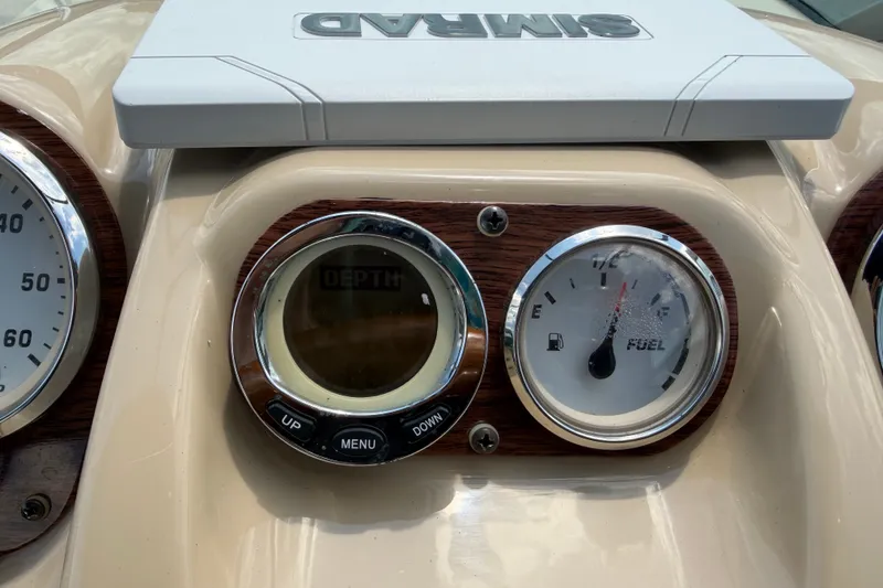 Slide: The Image of Dashboard of 2016 Glastron GS 259 boat with depth and fuel gauges. - 33