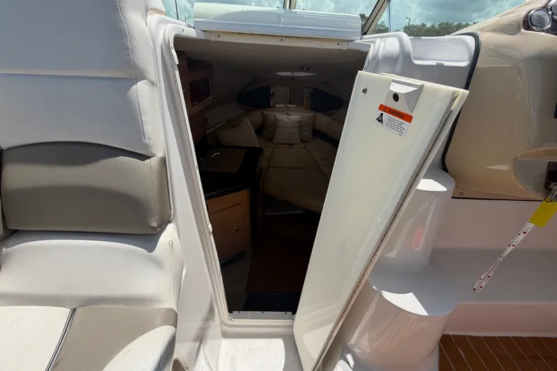 Slide: The Image of 2016 Glastron GS 259 cabin entrance with seating and interior view. - 39