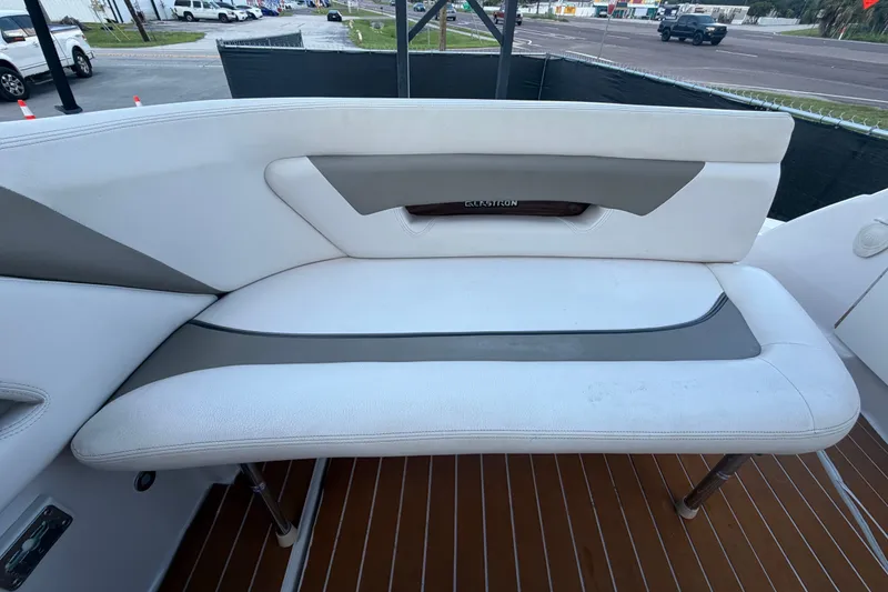 Slide: The Image of 2016 Glastron GS 259 boat interior with white cushioned seating and wood accents. - 88