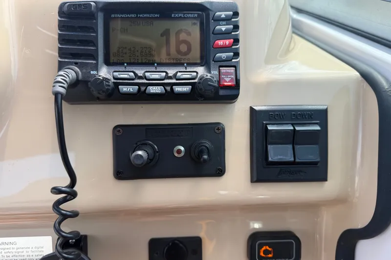 Slide: The Image of Control panel of a 2016 Glastron GS 259 boat with radio and switches. - 35