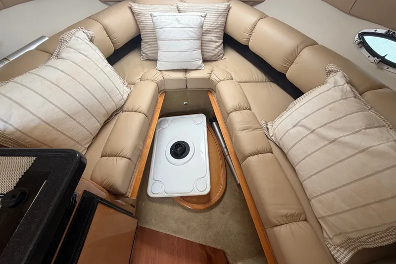 Slide: The Image of 2016 Glastron GS 259 cabin interior with beige seating and striped cushions. - 61