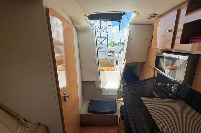 Slide: The Image of 2016 Glastron GS 259 boat interior with kitchenette and cabin view. - 69
