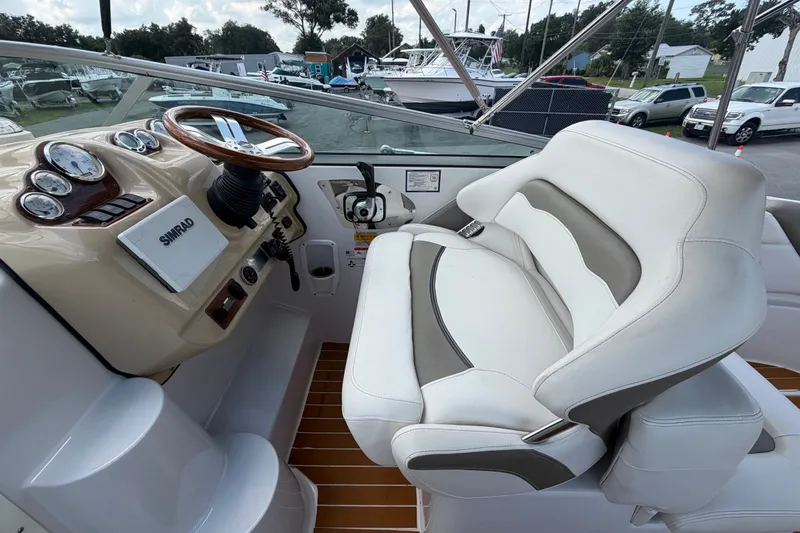 Slide: The Image of 2016 Glastron GS 259 boat cockpit with steering wheel and comfortable seating. - 28