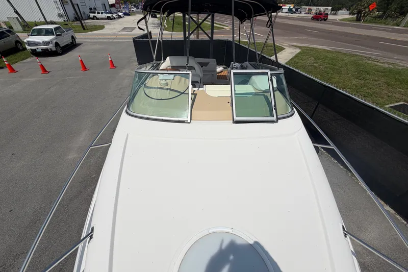 Slide: The Image of 2016 Glastron GS 259 boat with open cockpit, parked on pavement near traffic cones. - 75