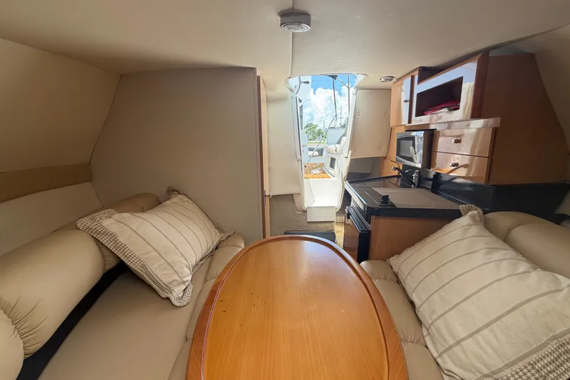 Slide: The Image of Interior of 2016 Glastron GS 259 boat with cozy seating and kitchenette. - 63