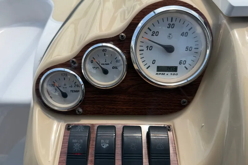 Slide: The Image of Dashboard of a 2016 Glastron GS 259 boat with gauges and switches. - 32