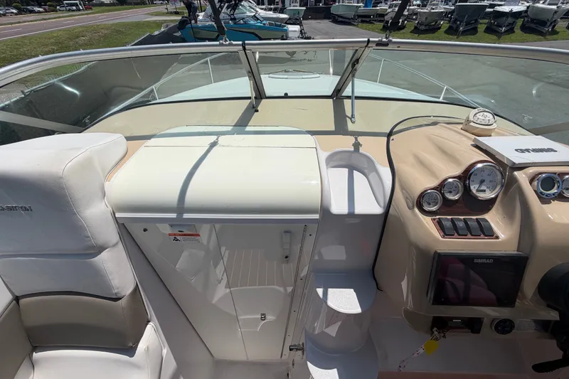 Slide: The Image of 2016 Glastron GS 259 boat cockpit with steering wheel, gauges, and seating. - 71