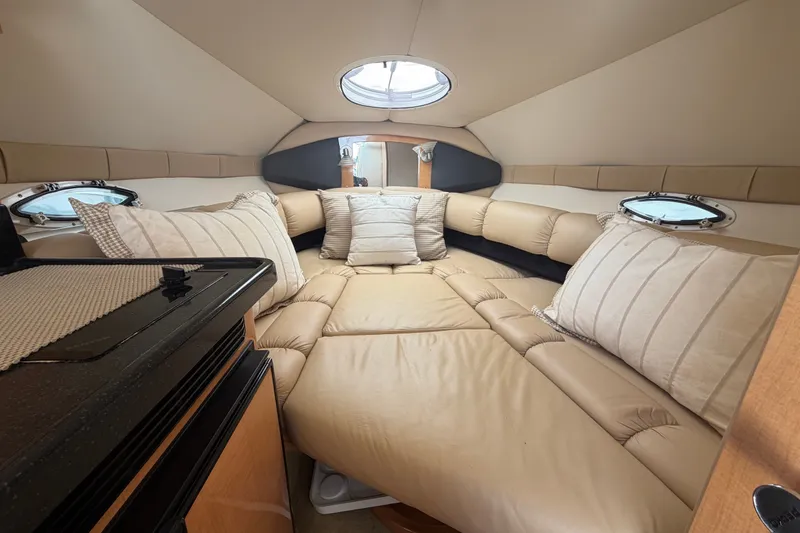 Slide: The Image of Interior of 2016 Glastron GS 259 boat with cozy beige seating and pillows. - 59