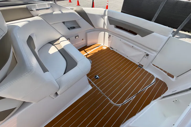 Slide: The Image of 2016 Glastron GS 259 boat interior with white seating and wood-patterned flooring. - 81