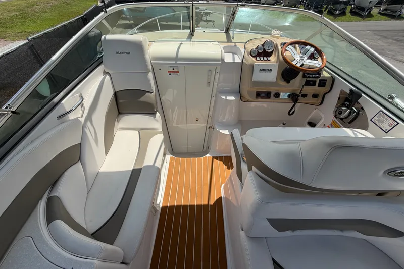 Slide: The Image of 2016 Glastron GS 259 boat interior with white seating and wood-accented flooring. - 24