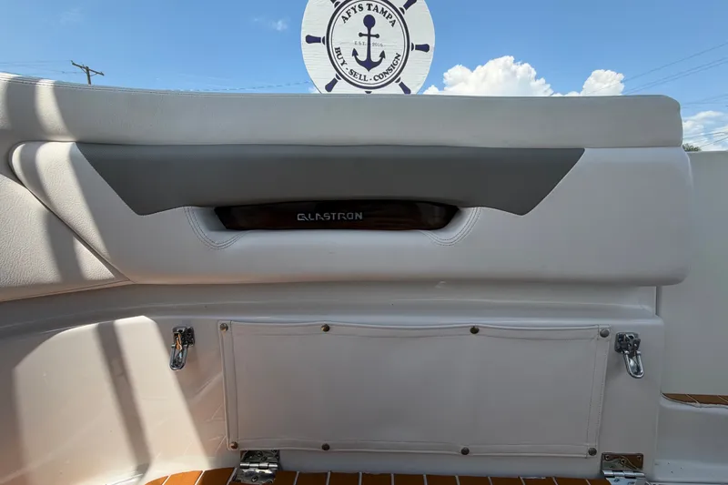 Slide: The Image of Interior view of a 2016 Glastron GS 259 boat, featuring sleek seating and storage. - 87