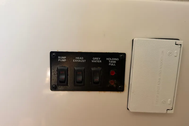 Slide: The Image of Control panel of a 2016 Glastron GS 259 boat with switches and indicators. - 68
